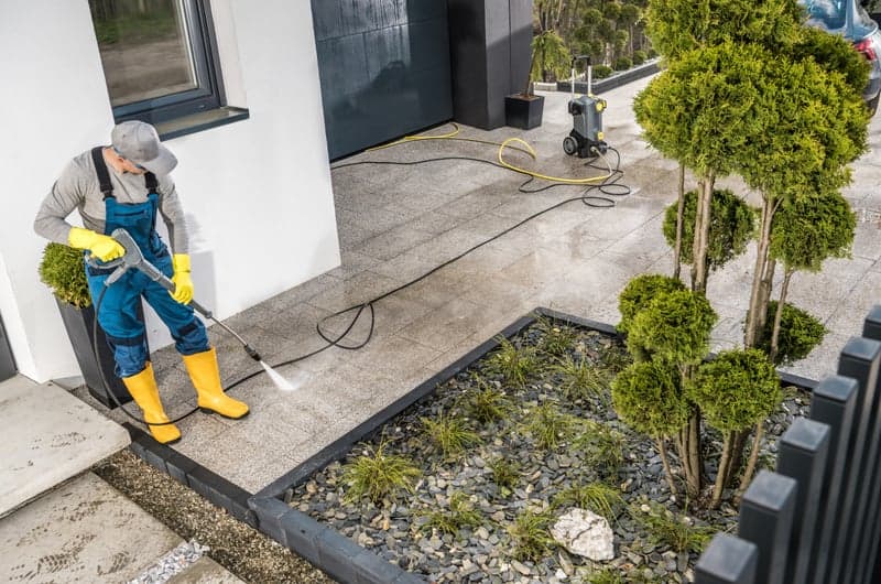 Before and after power washing a concrete driveway